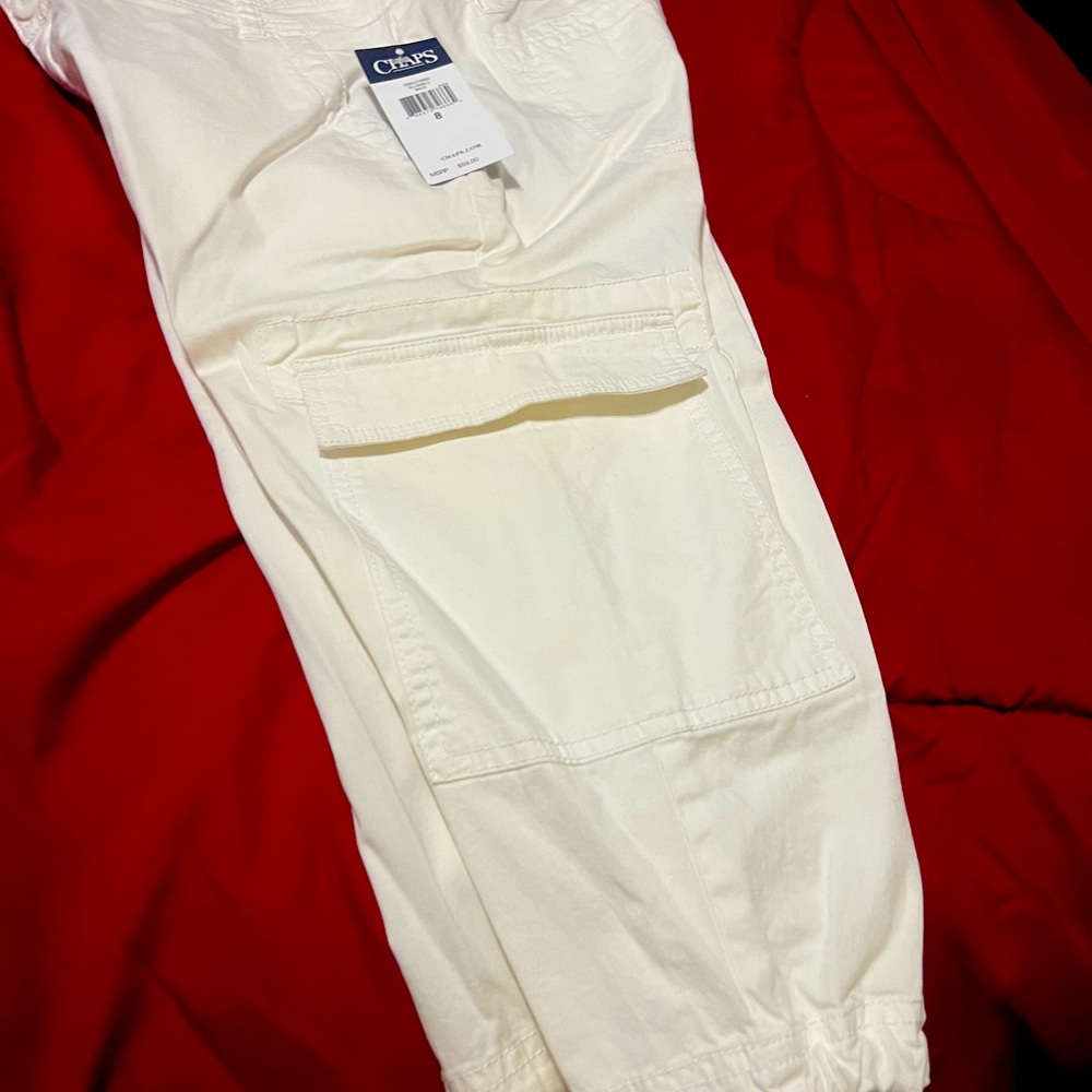 Brand new white denim cargo capri with drawstring legs.